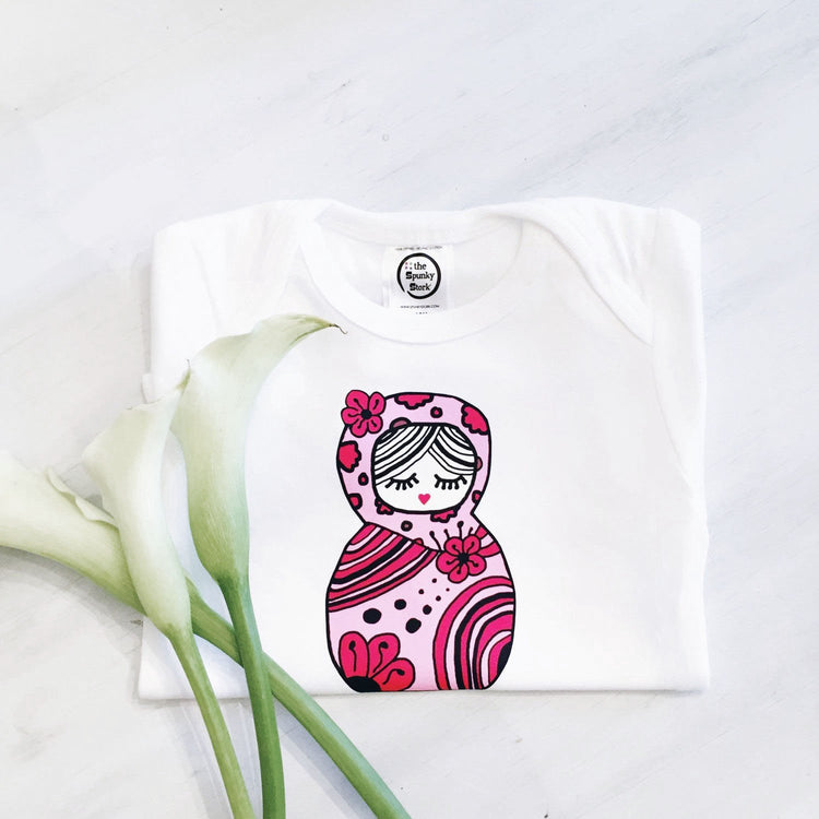 pink and red russian nesting doll retro toy print on organic cotton baby girl onesie toddler shirt